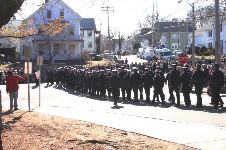 Firefighters march toward the wake for Boston Fire Lt. Edward Walsh. Photo by Charlie Breitrose