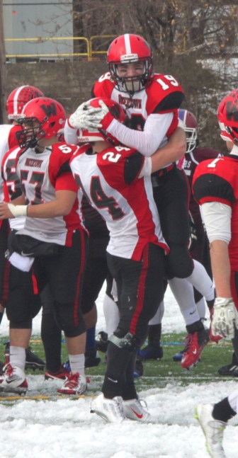 Watertown players celebrate beating Belmont in the Thanksgiving Day Game.