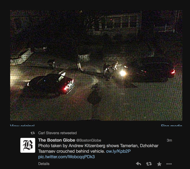 A photo taken by Laurel Street resident James Floyd of the Tsarnaevs crouching behind the Mercedes SUV during the shootout with Watertown Police, via the Boston Globe's Twitter feed.