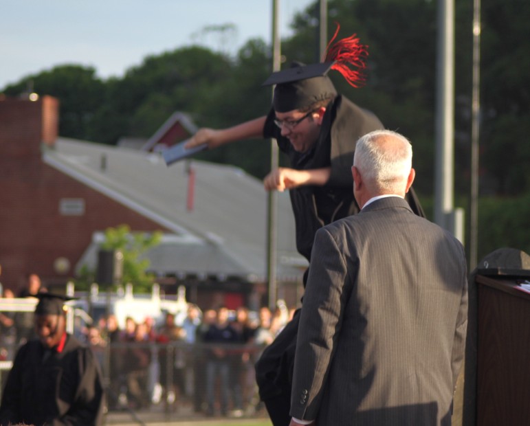 A new grad celebrates during the 2015 Watertown High School graduation. 