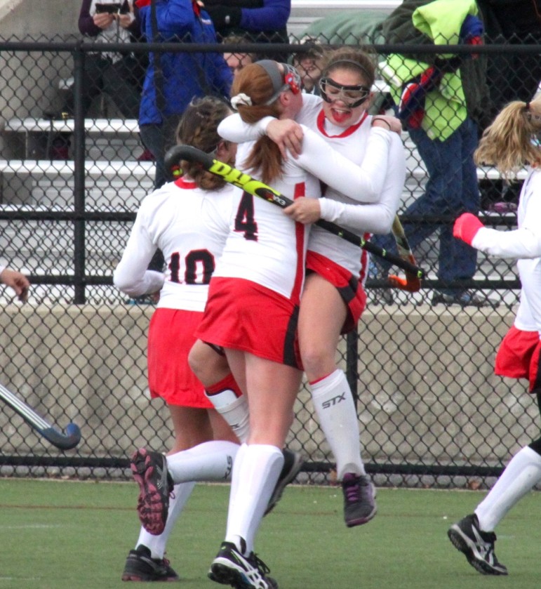 Watertown captain Michaela Antonellis leaps into the arm of her fellow captain Ally McCall after Watertown claimed the North Section title on Saturday.