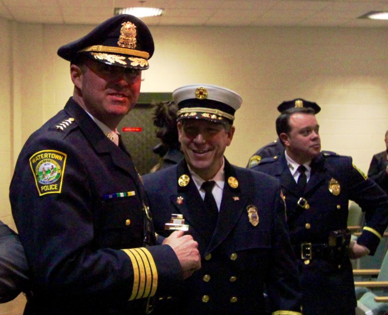 New Watertown Police Chief Michael Lawn speaks with Fire Chief Mario Orangio before Lawn's swearing in cermony.