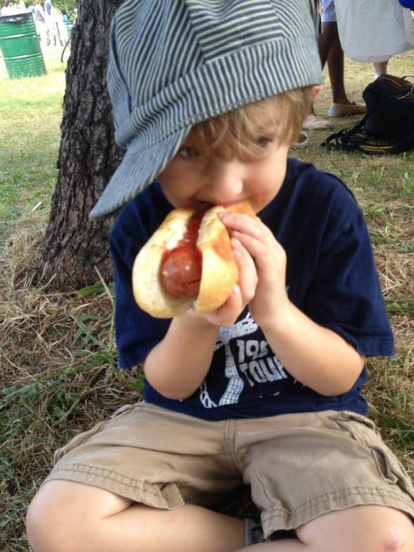 A boy enjoys a Trolley Dog. They are just one of the eating options on Food Truck Wednesdays.